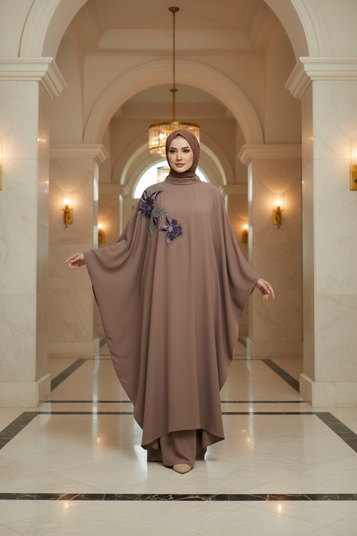 Model wearing brown butterfly cut abaya in elegant setting